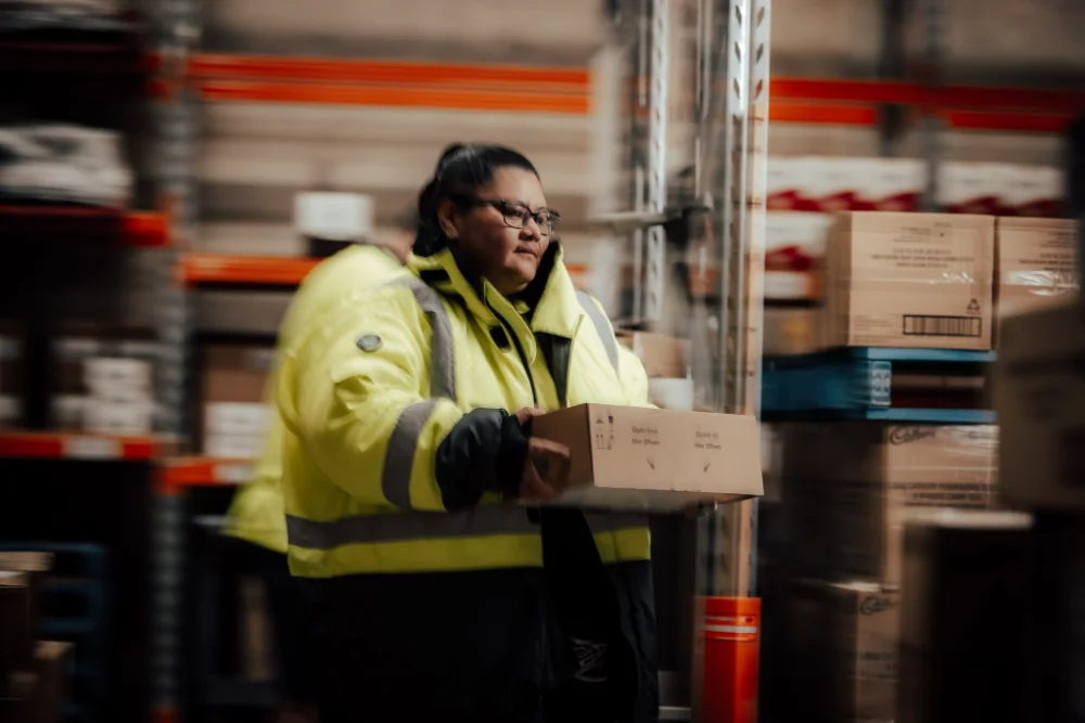 Warehouse team member picking a Cadbury order from racking