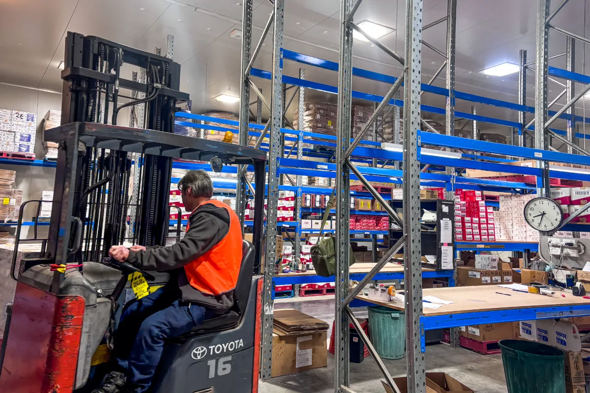 Forklift operator moving stock through the racking inside the Deliver and Store cold store